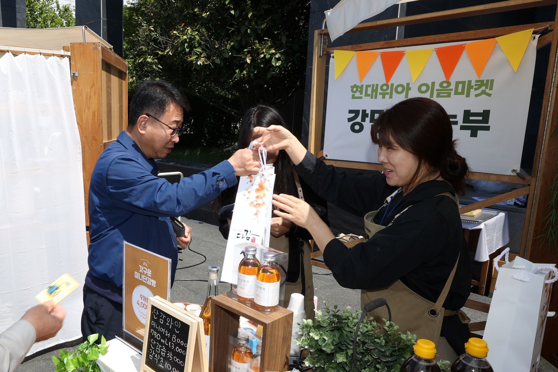 현대위아의 한 직원이 지난 9일 경상남도 창원특례시 현대위아 본사에서 열린 ‘이음마켓’에서 지역 농가에서 만든 제품을 사고 있다.